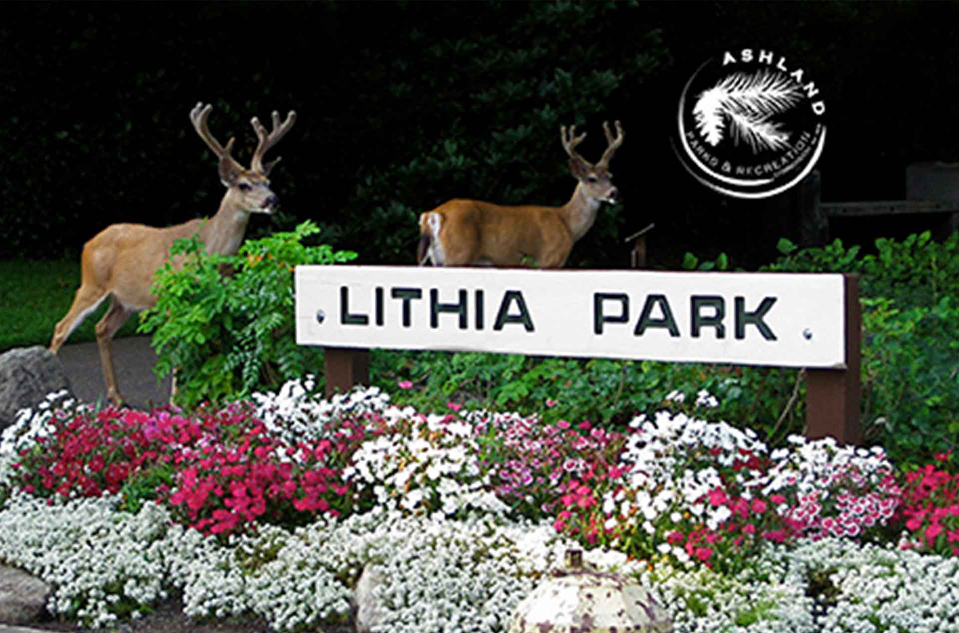 Lithia Park front entrance sign with two deer in the background.