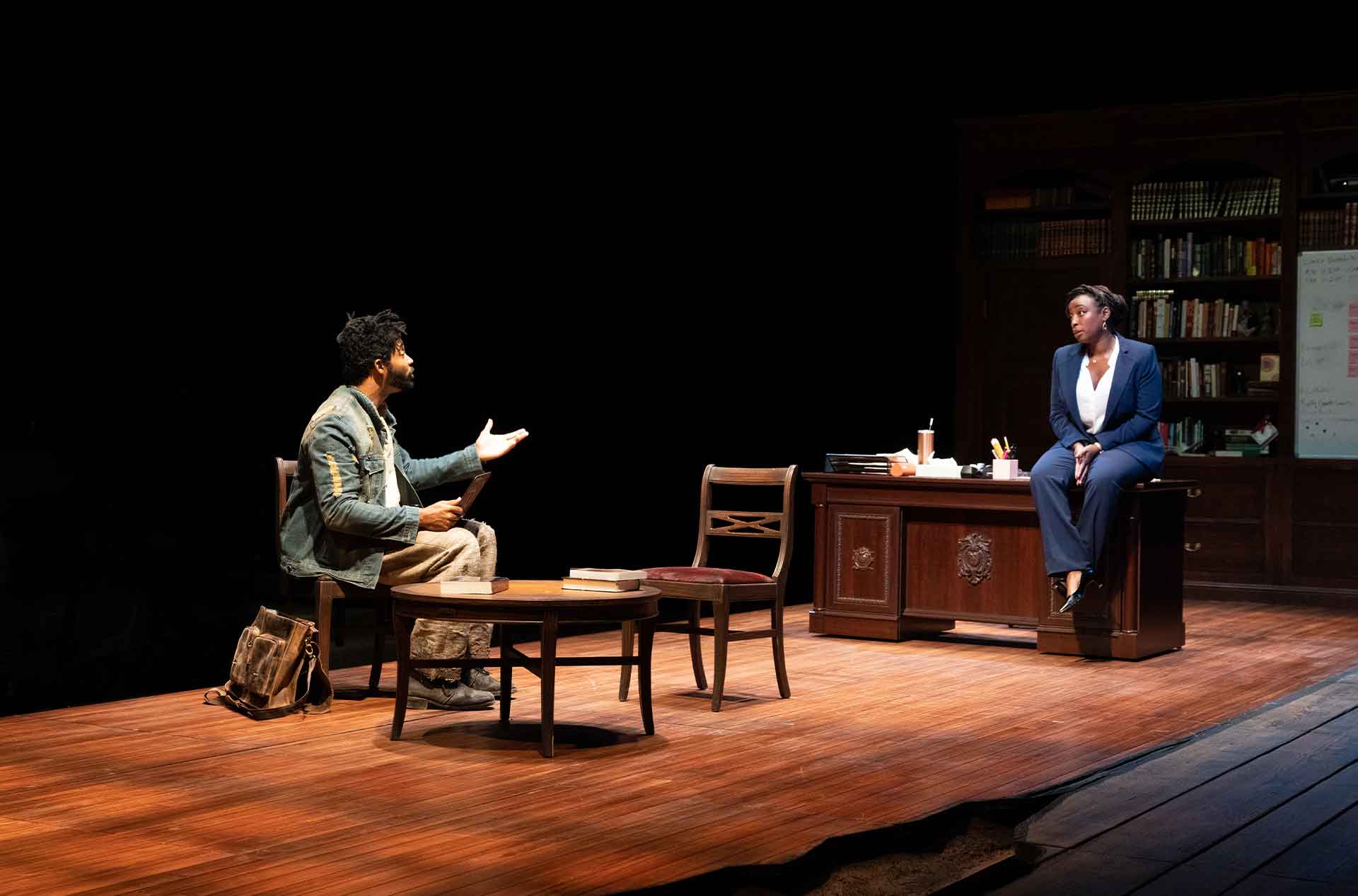 Two people talking to each other from across a small room.