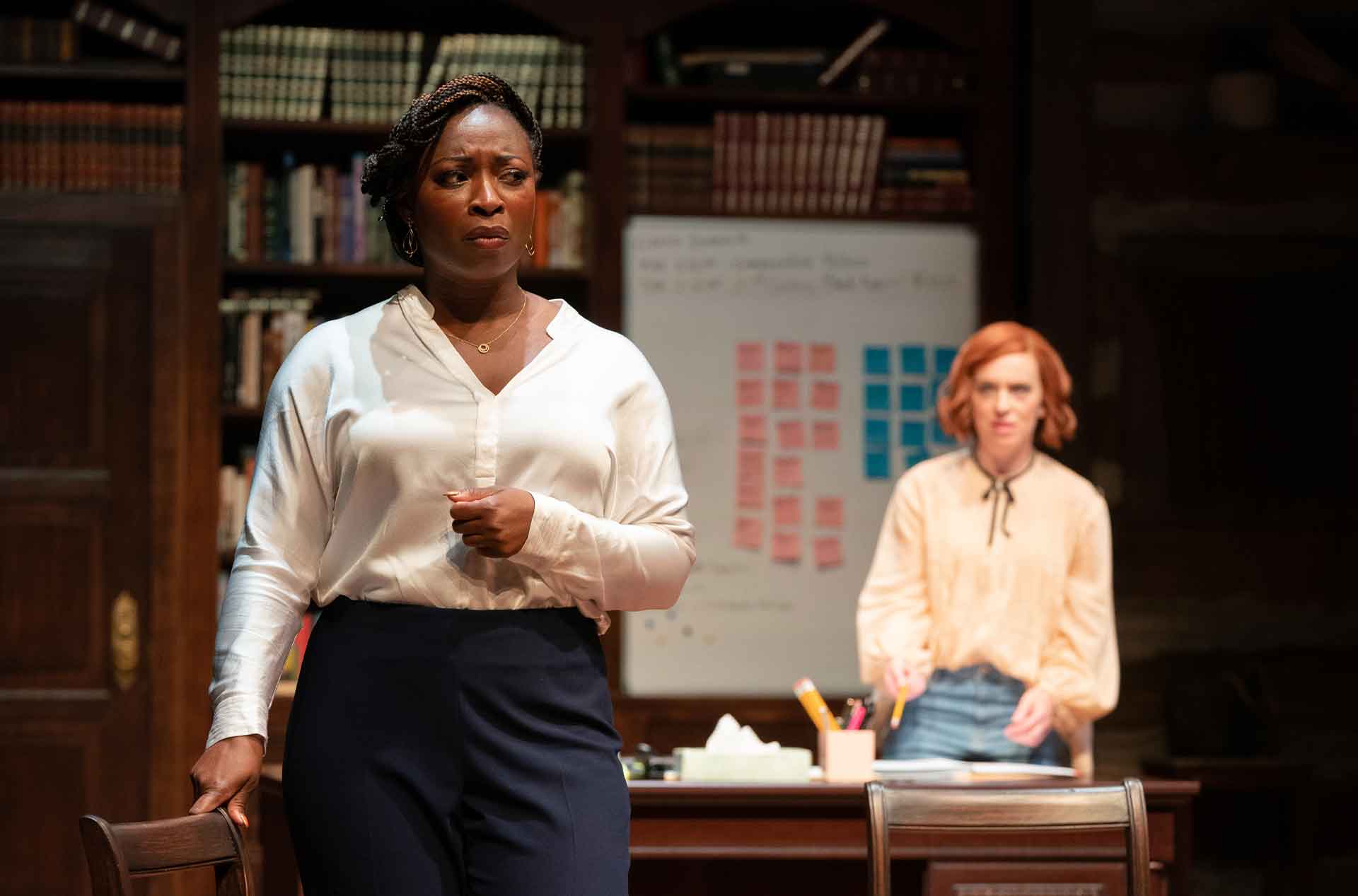 Person looking into distance with another person behind them.