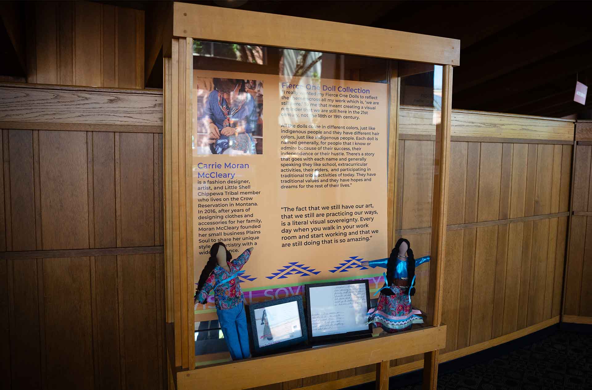 Glass display case with artwork inside.