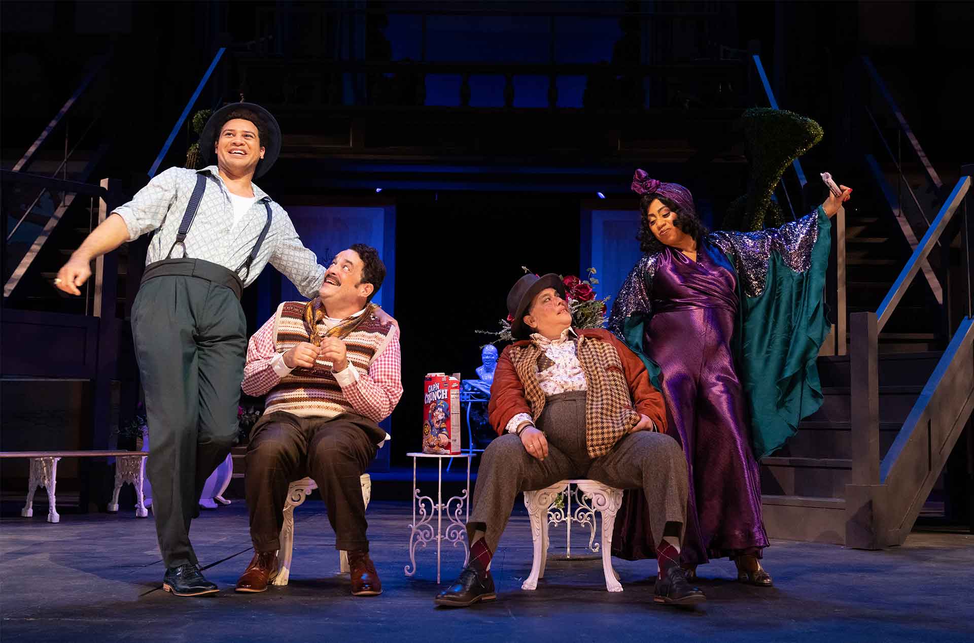 Two people standing beside two others seated in between them.