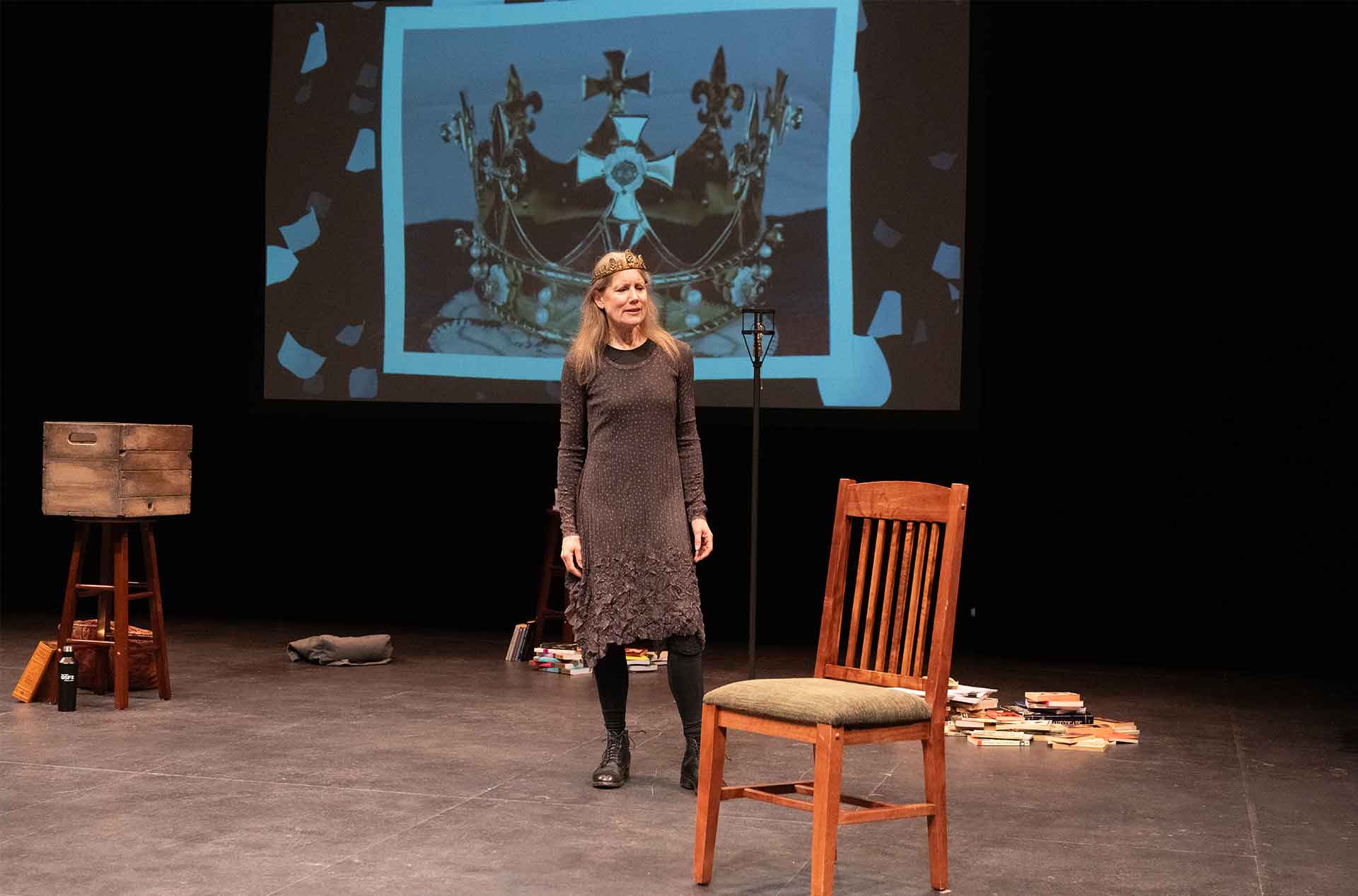 A woman standing in front of a projected photo.