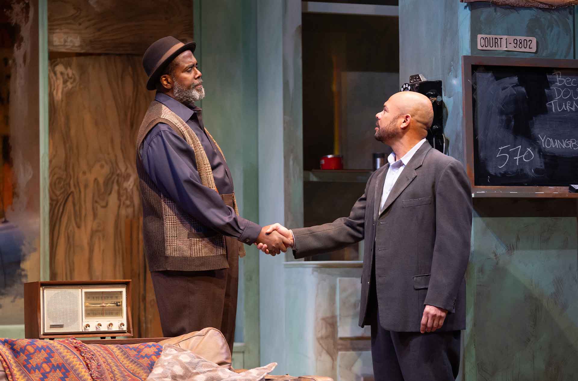 Two people exchange a firm handshake in a moment of agreement or understanding.