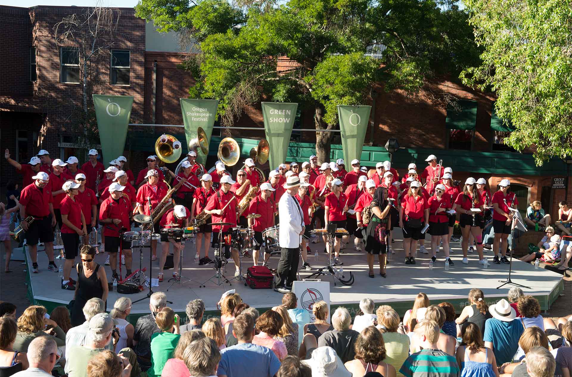 A group standing on a stage in front of a crowd.