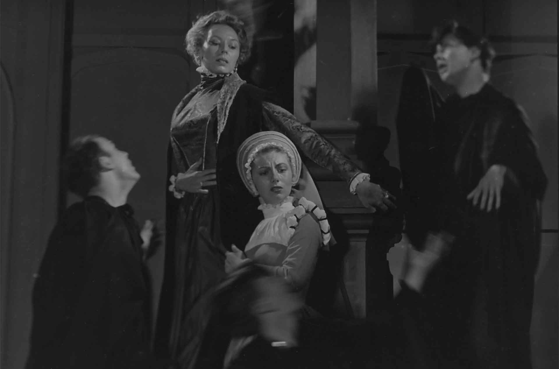 Four people standing together looking at different things.