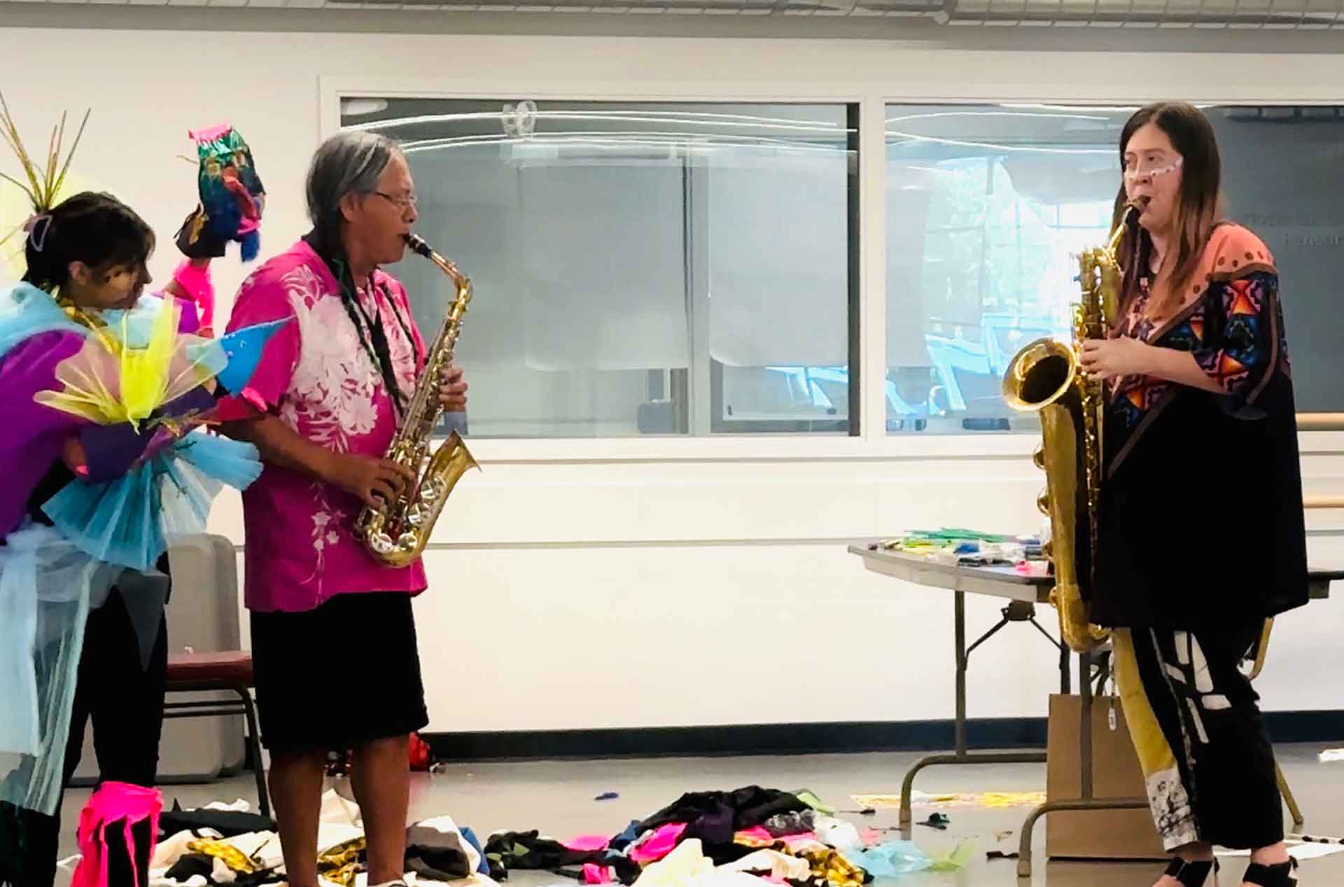 Three people playing musical instruments.