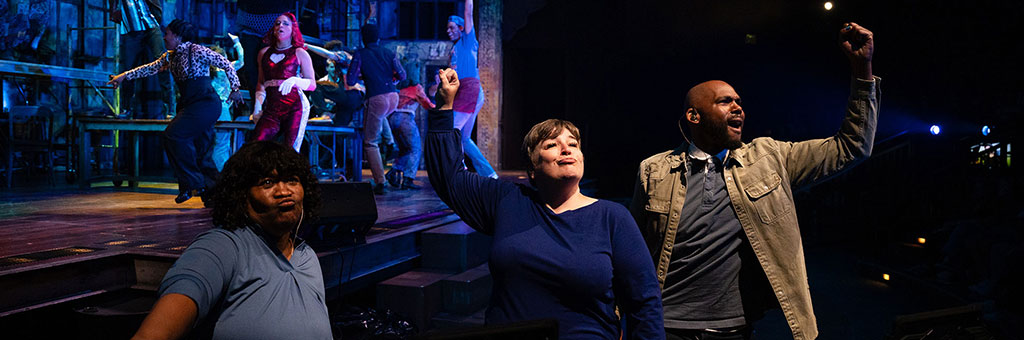 Three sign interpreters interpreting a show.