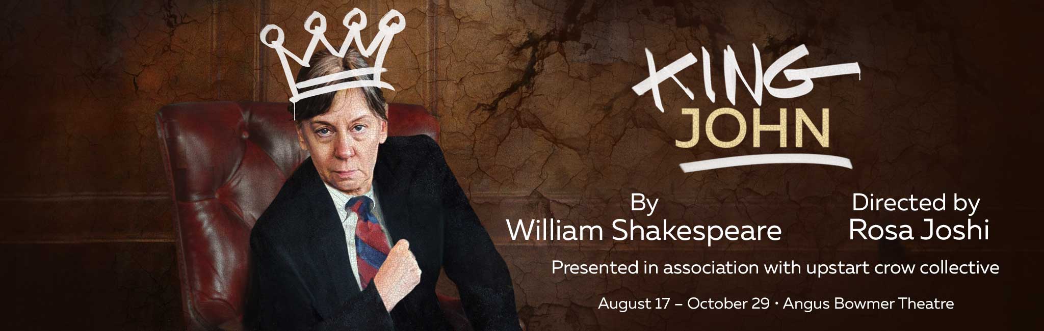 Actress Kate Wisniewski dressed in a suit sitting in a leather chair.