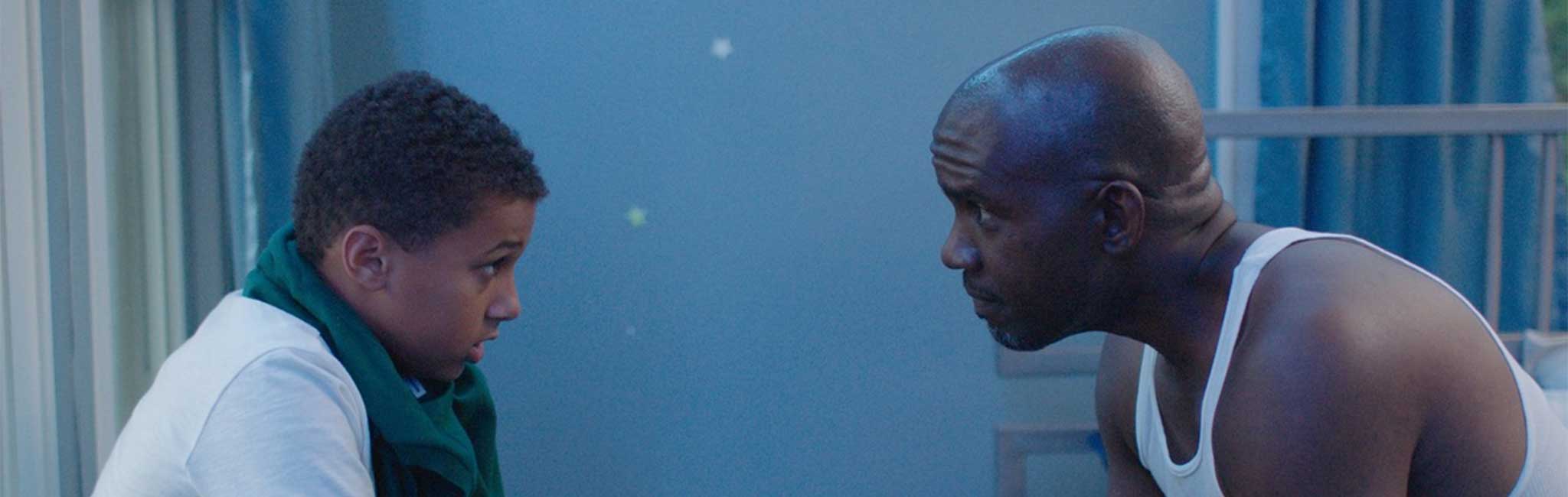 A teenager boy in discussion with his father.