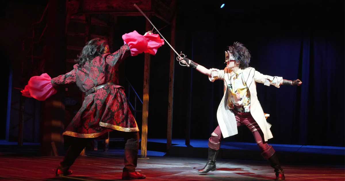 Two people sword fighting.